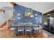 Dining room features a farmhouse table, stylish lighting, and a blue accent wall at 255 Kiowa Pl, Boulder, CO 80303