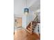 Bright foyer with hardwood floors, wooden staircase, and modern pendant lighting at 255 Kiowa Pl, Boulder, CO 80303