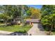 Charming single-story home features a brick facade, lush lawn, mature trees, and a two car garage at 255 Kiowa Pl, Boulder, CO 80303