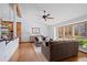 Cozy living room featuring hardwood floors, large windows, and a stylish ceiling fan at 255 Kiowa Pl, Boulder, CO 80303