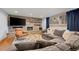 Cozy living room featuring a stone fireplace, large sectional couch, and a patterned rug at 255 Kiowa Pl, Boulder, CO 80303