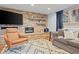 Cozy living room featuring a stacked stone fireplace, TV, and comfortable seating in a stylish setting at 255 Kiowa Pl, Boulder, CO 80303