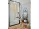 Modern tiled shower with glass door, bench, and decorative shelving unit with towels at 255 Kiowa Pl, Boulder, CO 80303