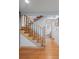 Staircase with wood steps, iron railing, and a view of the hall and bathroom in neutral tones at 255 Kiowa Pl, Boulder, CO 80303