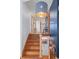 View of entryway staircase with wooden stairs, railing, and a unique light fixture at 255 Kiowa Pl, Boulder, CO 80303