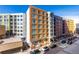 Contemporary multi-story apartment building with brick and white siding, modern windows, and street parking at 1700 Bassett St # 409, Denver, CO 80202
