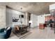 Elegant dining room with modern lighting, seating for four, and a striking piece of art at 1700 Bassett St # 409, Denver, CO 80202