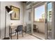 Bright workspace with desk, chair, stylish decor, and balcony access for a refreshing view at 1700 Bassett St # 409, Denver, CO 80202