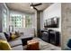 Cozy living area with a large window offering ample natural light and an entertainment center at 1700 Bassett St # 409, Denver, CO 80202