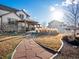 Expansive backyard featuring a stone path, pergola-covered patio, and lush landscaping at 10883 E 163Rd Ct, Brighton, CO 80602