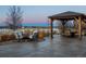 Inviting backyard patio with a covered gazebo and comfortable seating around a fire pit at 10883 E 163Rd Ct, Brighton, CO 80602