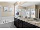 Spacious bathroom features a double sink vanity, soaking tub, and separate glass-enclosed shower at 10883 E 163Rd Ct, Brighton, CO 80602