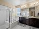 Well-lit bathroom with double vanity, a soaking tub, and a glass-enclosed shower for a spa-like experience at 10883 E 163Rd Ct, Brighton, CO 80602