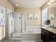 Bathroom with a shower, bathtub, and dark wood cabinets, offering both style and relaxation at 10883 E 163Rd Ct, Brighton, CO 80602