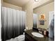 This bathroom features a shower with a stylish shower curtain and a granite countertop sink at 10883 E 163Rd Ct, Brighton, CO 80602