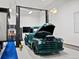 Spacious garage featuring a restored vintage truck, car lift, and ample workspace at 10883 E 163Rd Ct, Brighton, CO 80602