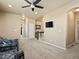 Open-plan hallway features neutral walls, carpet flooring, and an open view to the staircase at 10883 E 163Rd Ct, Brighton, CO 80602