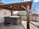 Covered hot tub area with string lights, providing a relaxing outdoor space at 10883 E 163Rd Ct, Brighton, CO 80602