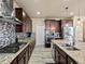 Modern kitchen with granite countertops, stainless steel appliances, and custom cabinetry at 10883 E 163Rd Ct, Brighton, CO 80602