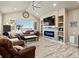 Cozy living room with a vaulted ceiling, fireplace, and large window with a view at 10883 E 163Rd Ct, Brighton, CO 80602