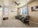 Comfortable living room with neutral walls, a ceiling fan, and two armchairs near windows at 10883 E 163Rd Ct, Brighton, CO 80602