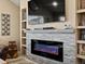 Living room showcasing modern fireplace, built-in shelving, and comfortable seating area at 10883 E 163Rd Ct, Brighton, CO 80602