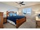 Cozy main bedroom with a large bed, soft carpet, and a window view of the neighborhood at 10883 E 163Rd Ct, Brighton, CO 80602