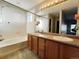 Bathroom with double sink vanity, shower over tub, and plenty of natural light at 21993 E Jamison Pl, Aurora, CO 80016