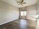 This bedroom has neutral walls, hardwood floors and a window with curtains and blinds at 21993 E Jamison Pl, Aurora, CO 80016
