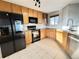 Well-lit kitchen featuring stainless steel appliances, light wood cabinets, and granite countertops at 21993 E Jamison Pl, Aurora, CO 80016