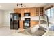 Granite countertops highlight the updated kitchen featuring black appliances and wood cabinetry at 21993 E Jamison Pl, Aurora, CO 80016