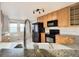 Kitchen area featuring granite countertops, stainless steel appliances, and modern lighting at 21993 E Jamison Pl, Aurora, CO 80016