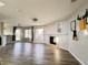 Bright, open-concept living area features wood-look floors, a cozy fireplace, and large windows at 21993 E Jamison Pl, Aurora, CO 80016