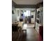 Cozy dining area with a wooden table and bench, seamlessly connected to a bright and organized kitchen space at 188 S Dale Ct, Denver, CO 80219