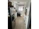 Galley kitchen with tile floors, white cabinets, and stainless steel refrigerator at 188 S Dale Ct, Denver, CO 80219