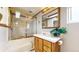 Bathroom featuring a shower with a glass enclosure and a vanity with a mirror at 8509 Colorado Ct, Denver, CO 80229