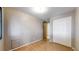 This bedroom features hardwood floors, neutral walls, a ceiling light and a double-door closet at 8509 Colorado Ct, Denver, CO 80229