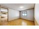 Another bedroom featuring hardwood floors and a bright window offering ample light at 8509 Colorado Ct, Denver, CO 80229