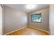 Cozy bedroom with gleaming hardwood floors and a bright window offering natural light and outdoor views at 8509 Colorado Ct, Denver, CO 80229