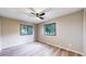A spacious bedroom with ample light from the two well-lit windows at 8509 Colorado Ct, Denver, CO 80229