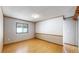 A large bedroom with hardwood floors and a bright window offering ample light at 8509 Colorado Ct, Denver, CO 80229