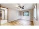 Comfortable bedroom featuring a ceiling fan, new flooring, and windows to let in natural light at 8509 Colorado Ct, Denver, CO 80229