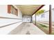 Carport attached to the home with a concrete floor and white siding at 8509 Colorado Ct, Denver, CO 80229