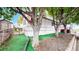 Charming home with a white exterior, complemented by vibrant green grass and mature trees at 8509 Colorado Ct, Denver, CO 80229