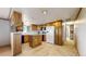 Bright kitchen with wooden cabinetry, tile floors, and modern appliances at 8509 Colorado Ct, Denver, CO 80229