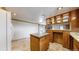 Spacious kitchen featuring tile floors, ample cabinet space, and a center island perfect for culinary enthusiasts at 8509 Colorado Ct, Denver, CO 80229