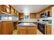 Cozy kitchen featuring wooden cabinetry, tile floors, and kitchen island at 8509 Colorado Ct, Denver, CO 80229
