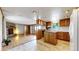 Open concept kitchen and living room featuring wooden cabinetry and lots of natural light at 8509 Colorado Ct, Denver, CO 80229