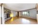 Spacious living room featuring hardwood floors, a stone fireplace, and large windows at 8509 Colorado Ct, Denver, CO 80229