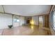 View of living room with stone fireplace, hardwood floors, and large windows at 8509 Colorado Ct, Denver, CO 80229